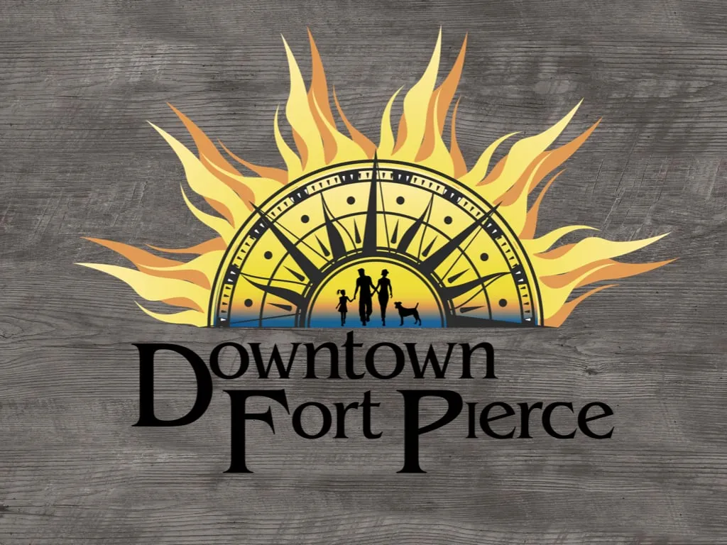 Full-color Downtown Fort Pierce sunburst logo on wood