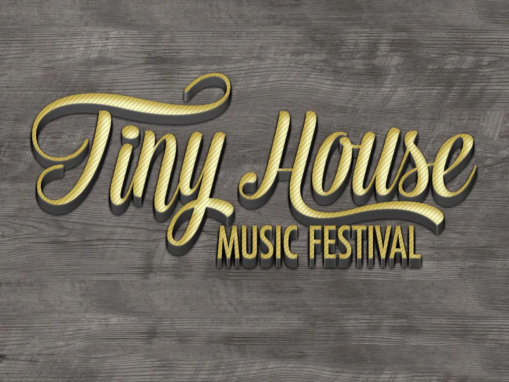 Gold script Tiny House Music Festival wordmark on wood
